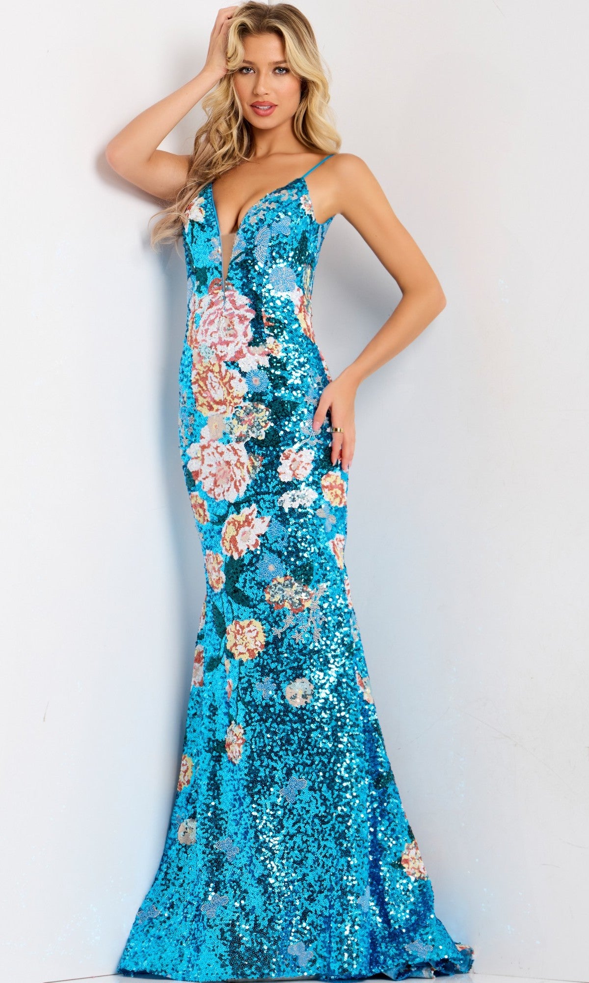 A woman in a blue Long Prom Dress: Jovani 48637, adorned with floral sequins and featuring a stunning mermaid silhouette.